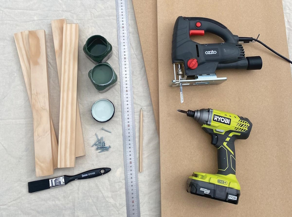 Materials and tools laid out: pine wood, screws, jigsaw, drill, and paint tins